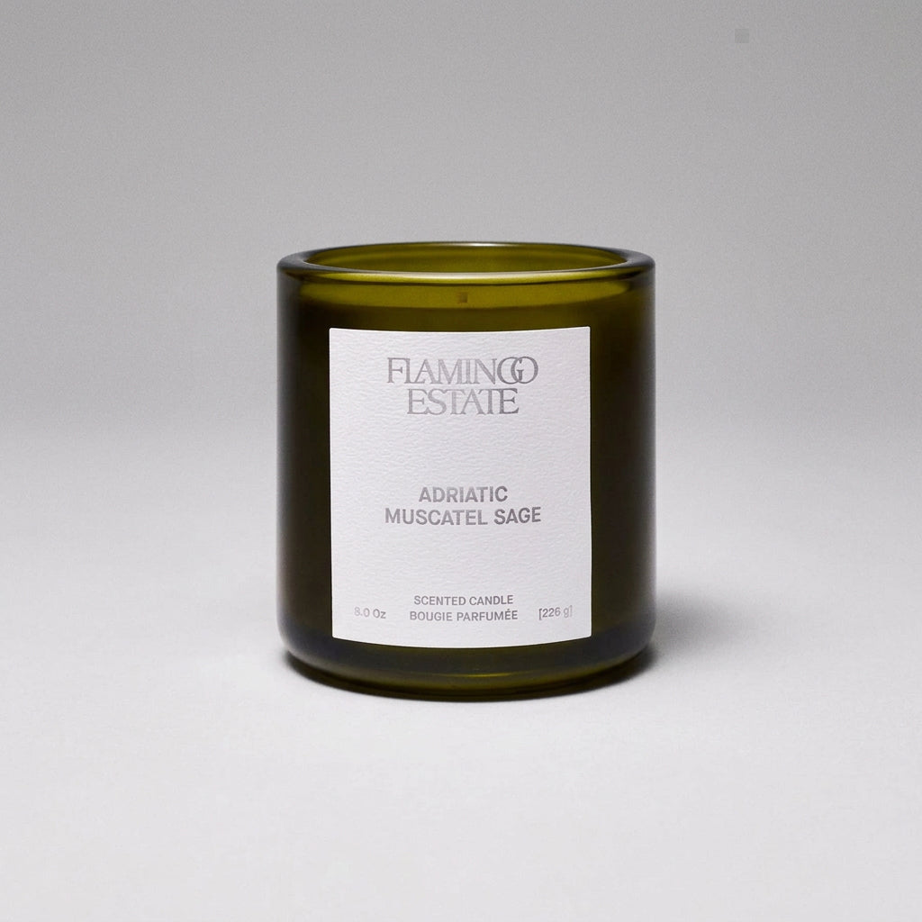 Green candle with a white label on a white background