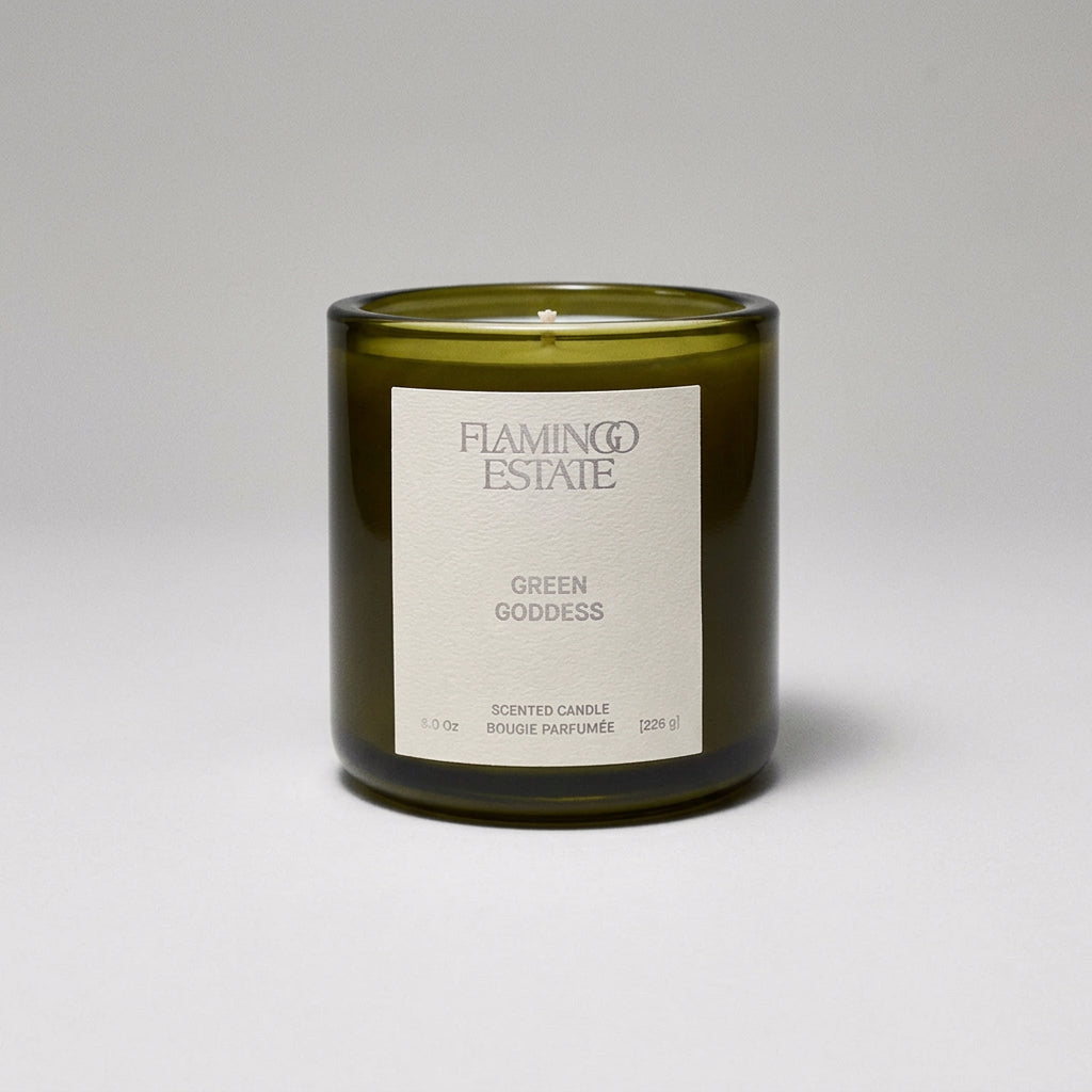 Green candle with a label on a white background