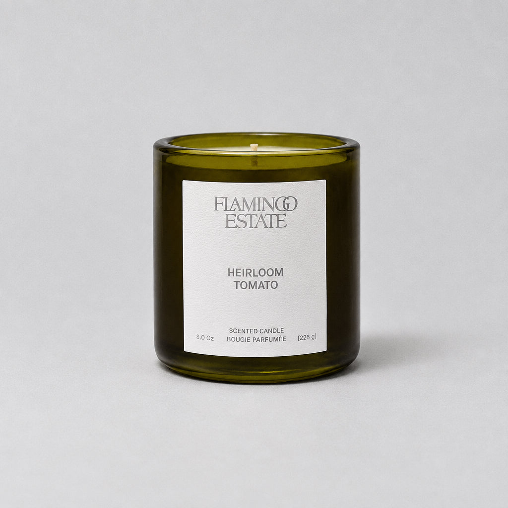 Green candle with a white label on a white background