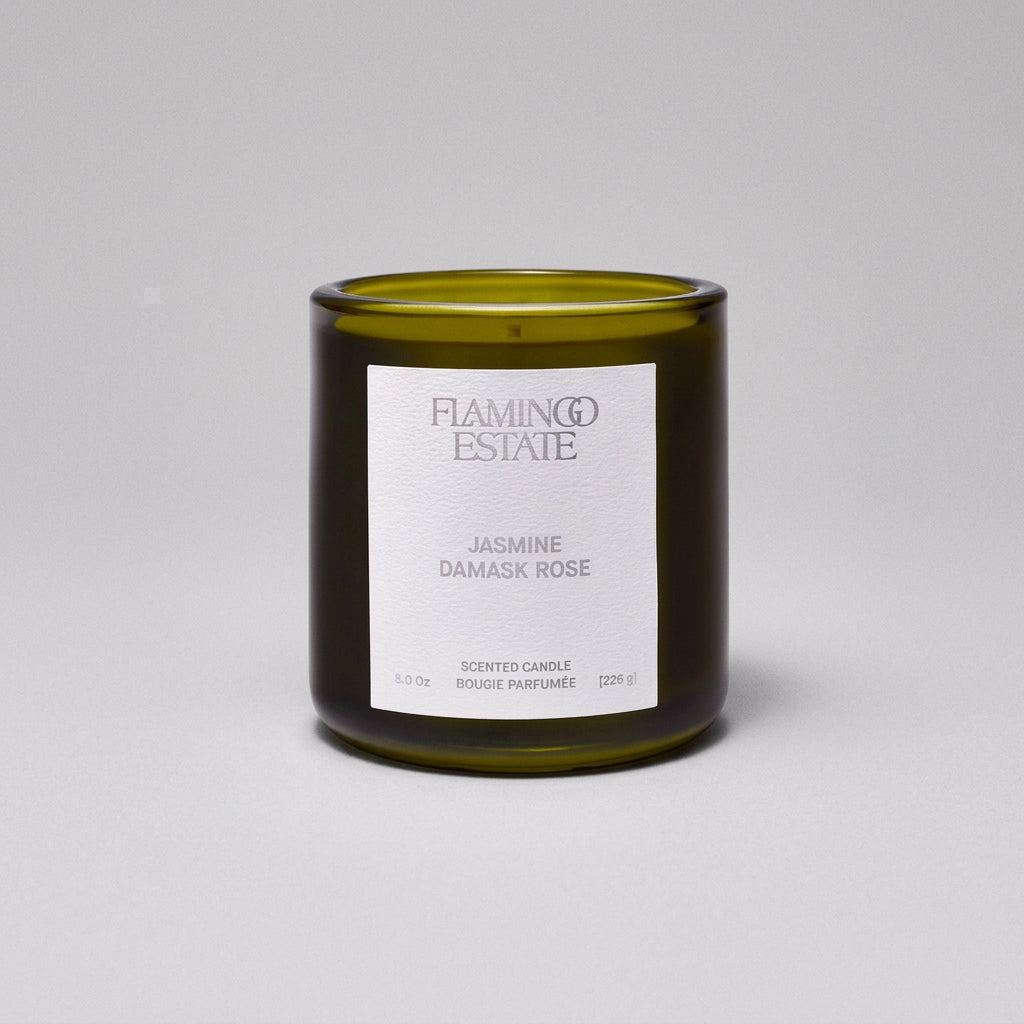 Green candle with a white label on a white background