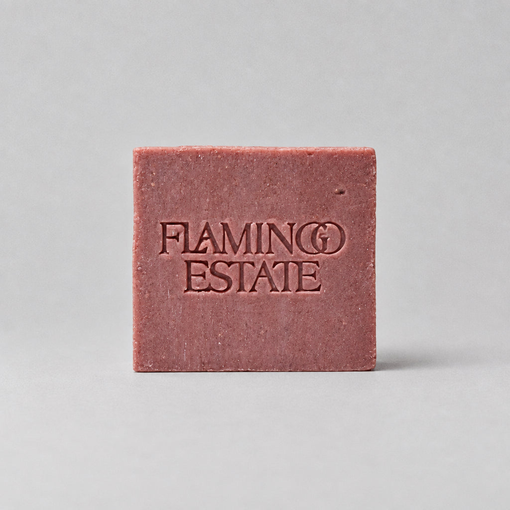 Red bar of soap with 'Flamingo Estate' branding on a white background