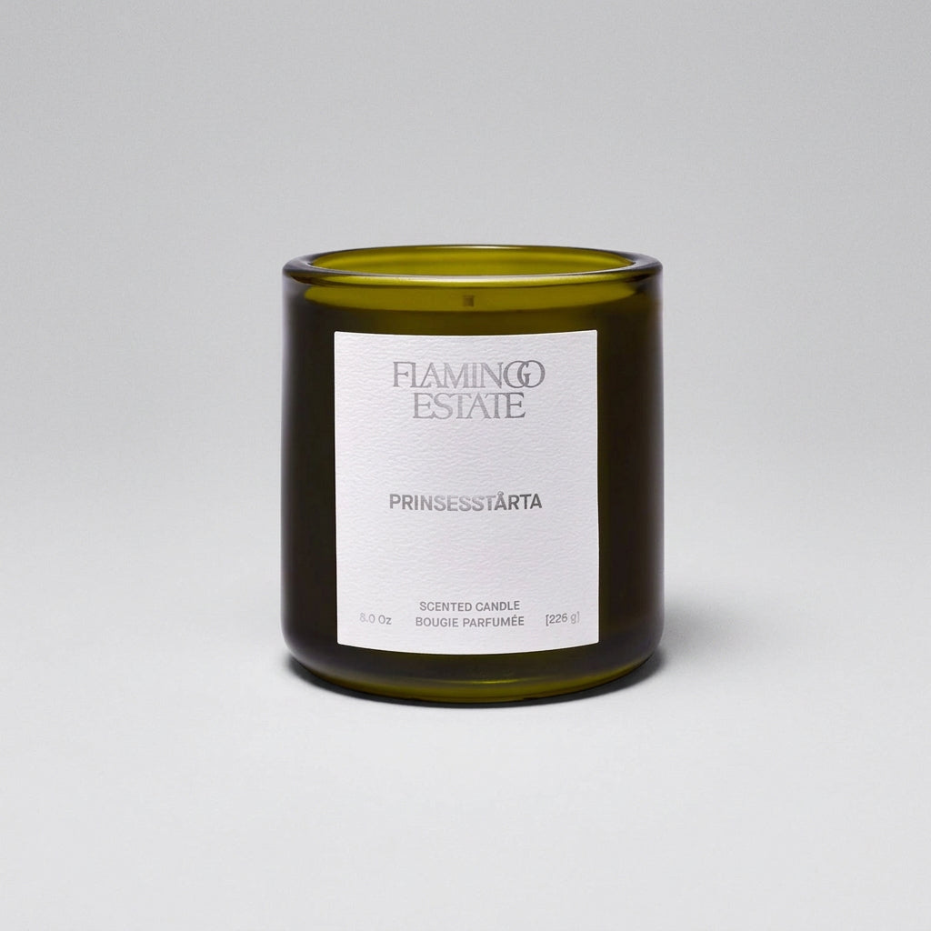 Green candle with a label on a white background